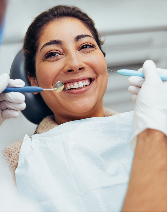 Woman in dental chair about to undergo scaling and root planing